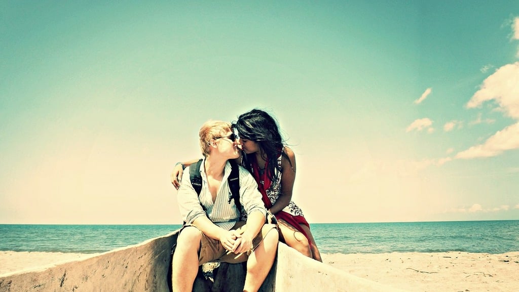 Couple kissing on the beach.